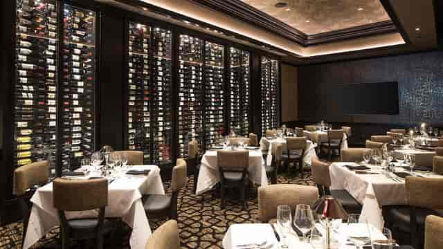 Elegant Tuscany Room with wine wall, ideal for intimate dining and business meetings.