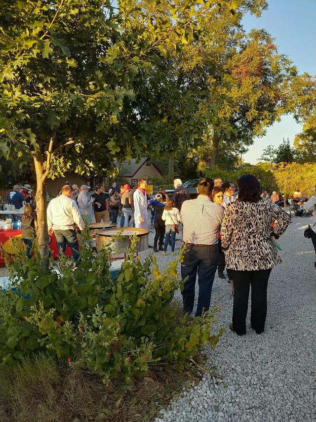 Outdoor networking event at The Cliff House with inviting patio and lush greenery.