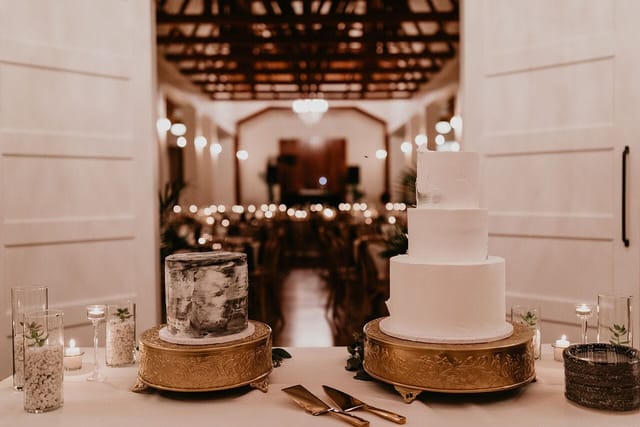 Elegant wedding cakes in a beautifully lit reception space at The Cliff House.