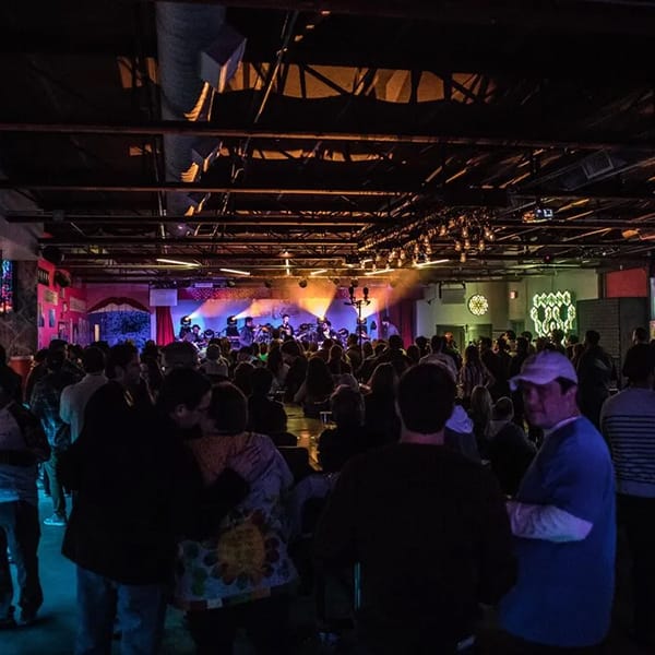 "Live music venue Deep Ellum Art Company with vibrant crowd and colorful lighting, perfect for events."