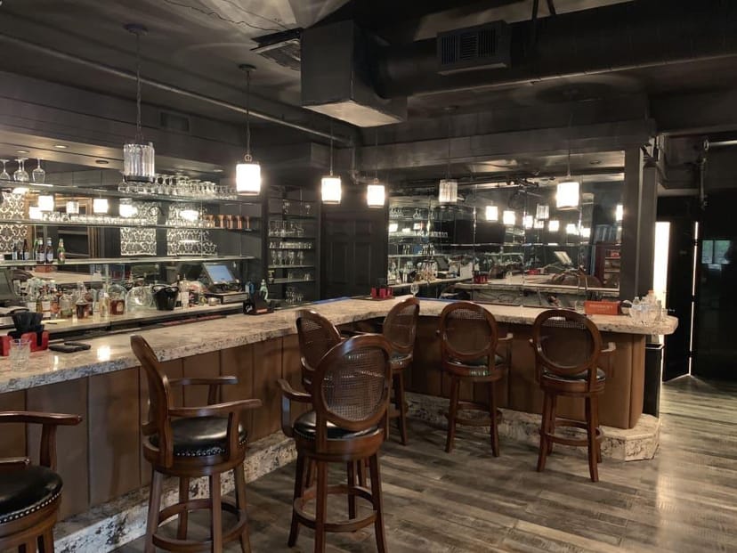 Modern bar in Central Houston, polished countertops, ideal for networking events.
