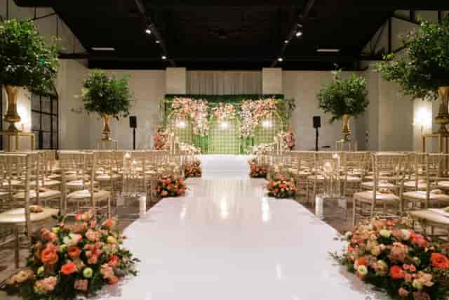 Elegant wedding ceremony setup in The Revaire's Great Room with floral arrangements.
