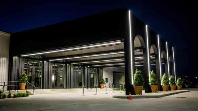 Modern venue entrance with sleek lines and warm lighting for upscale events.