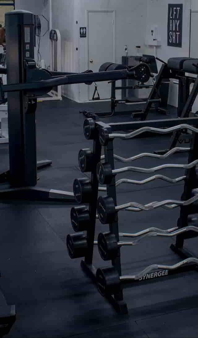 Houston Athletic Club's gym with dumbbell rack, perfect for fitness events and wellness retreats.