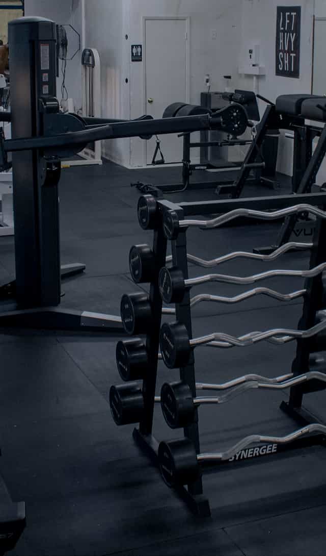 Houston Athletic Club's gym with dumbbell rack, perfect for fitness events and wellness retreats.