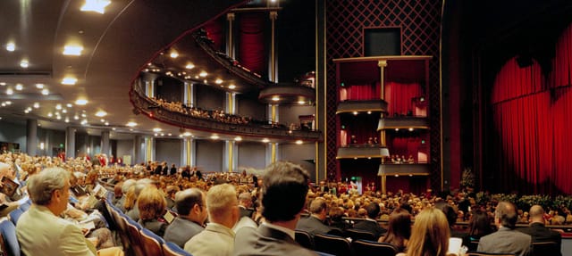 Packed theater auditorium with tiered seating for impactful events and dynamic presentations.