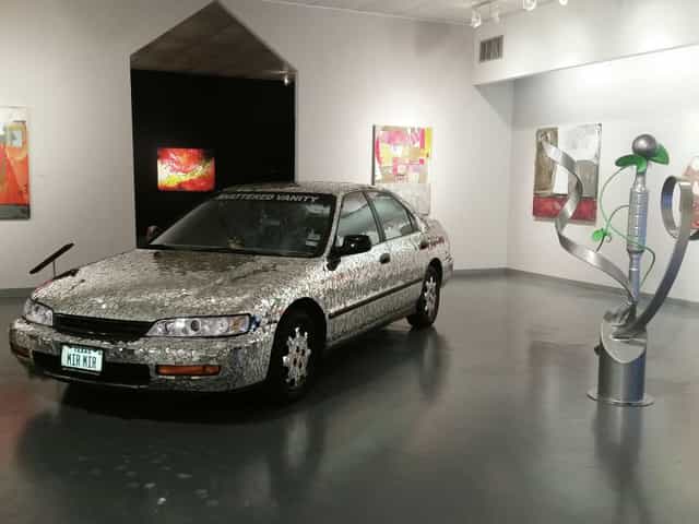 Art Car Museum exhibit: creatively adorned car in gallery, perfect for unique events.
