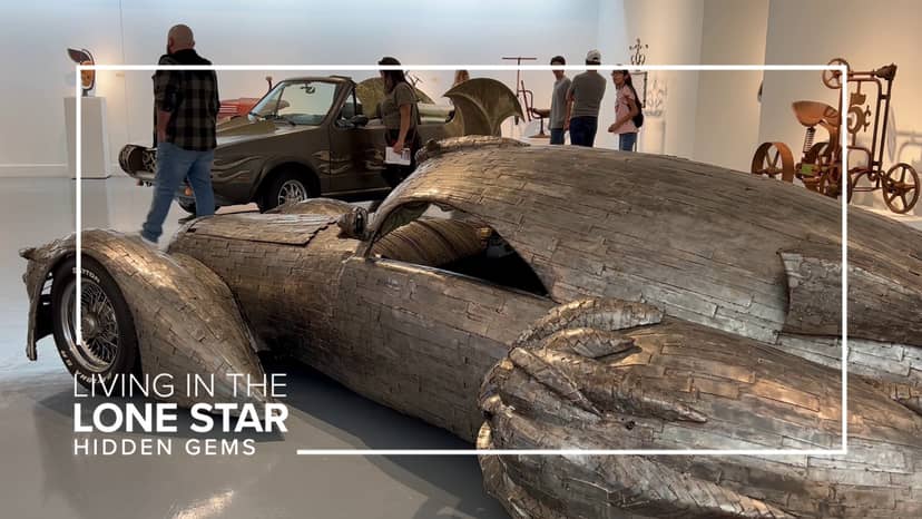 Metal car sculpture in Art Car Museum's Exhibition Gallery for unique art events.