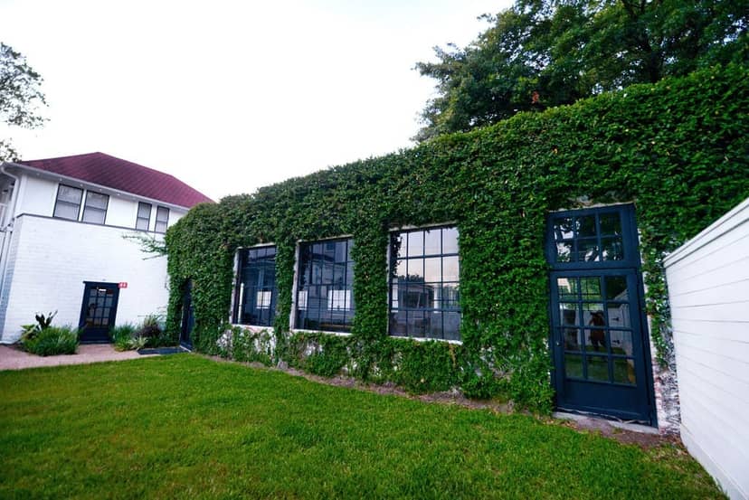 Carriage House venue with lush greenery, ideal for intimate meetings and celebrations.
