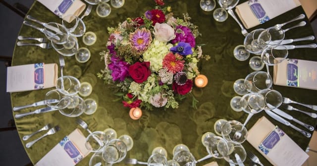 Elegant dining table setup with vibrant centerpiece for sophisticated events.