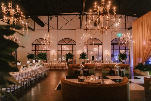 Event planner in elegant venue with chandeliers for weddings and corporate events.