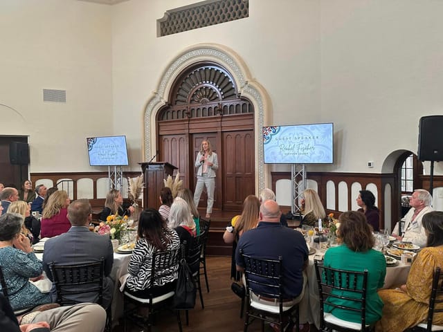 Cloister Room corporate event with engaging speaker and stylish decor.