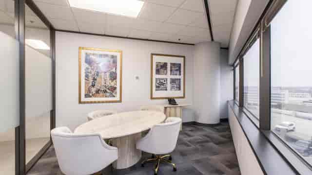 Modern conference room in Houston with circular table for effective meetings and collaborations.