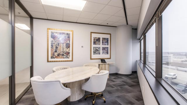 Modern conference room in Houston with circular table for effective meetings and collaborations.
