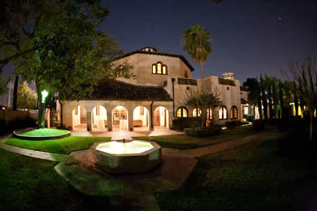 Cloister Room at The Parador, illuminated venue for elegant receptions and evening events.