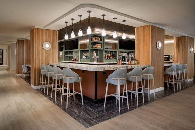 Modern bar area in Sheraton Fort Worth, ideal for networking events and gatherings.