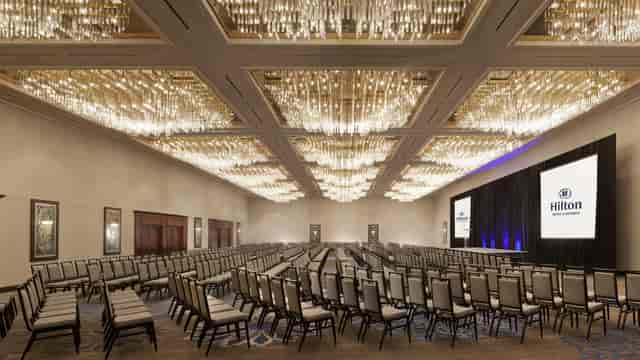 Elegant Hilton Fort Worth ballroom with chandeliers for corporate meetings and conferences.