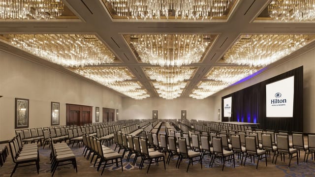 Elegant Hilton Fort Worth ballroom with chandeliers for corporate meetings and conferences.