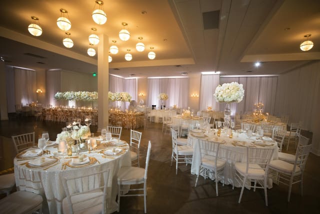 Elegant ballroom venue with floral centerpieces for weddings and upscale events.