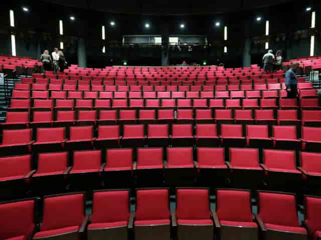 Hubbard Stage at Alley Theatre with vibrant red seats for engaging performances and events.