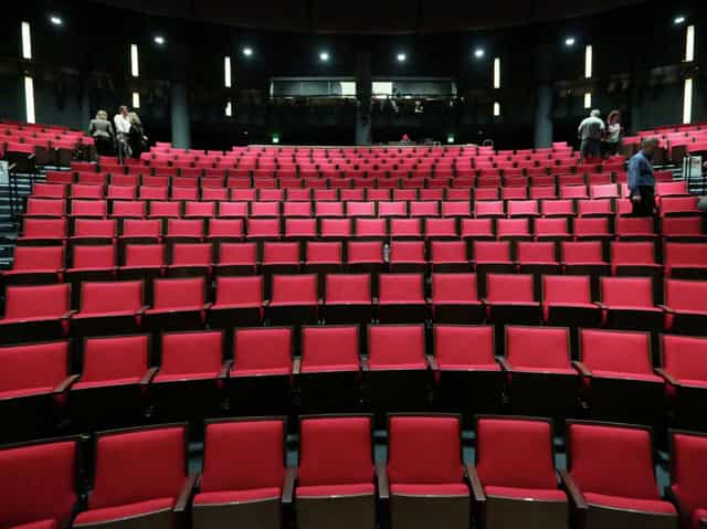 Hubbard Stage at Alley Theatre with vibrant red seats for engaging performances and events.