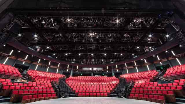 Modern amphitheater with red seating, ideal for events and performances in Alley Theatre.