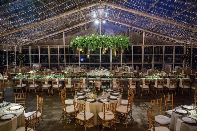 Elegant banquet space under clear-top tent at Arlington Hall for weddings and corporate events.