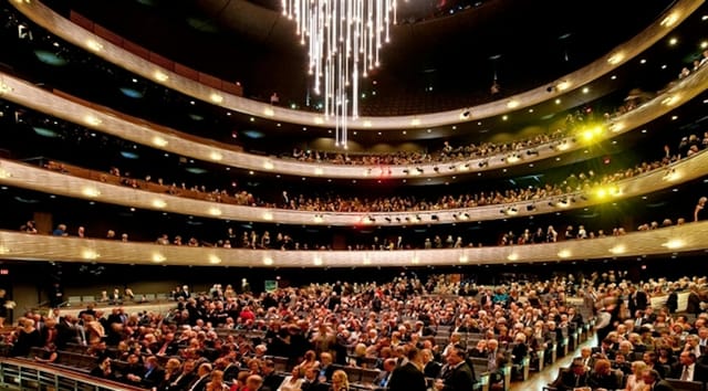 Studio Theatre auditorium with elegant seating and chandelier, perfect for performances and galas.
