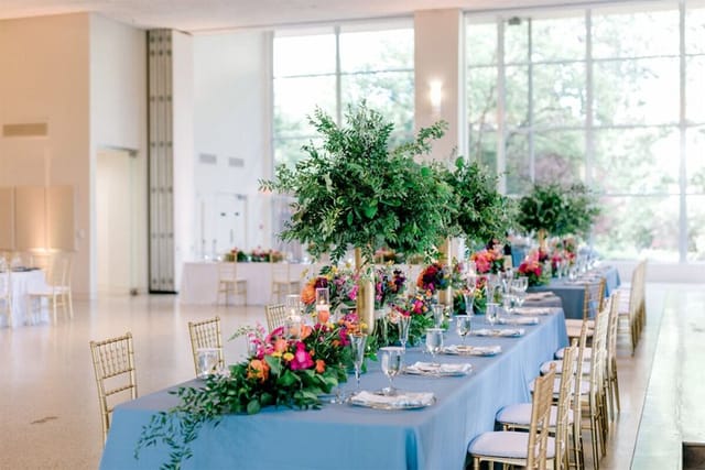 Elegant Grand Hall event space in Texas with floral centerpieces and natural light.