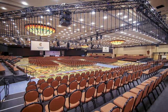 Spacious Grapevine Convention Center event hall with stage, ideal for conferences or seminars.