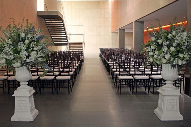 Elegant ceremony setup at Asia Society Texas with floral arrangements and modern architecture.