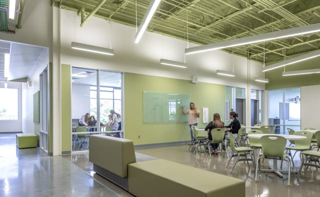 Modern Houston school cafeteria with movable furniture for collaborative workshops.