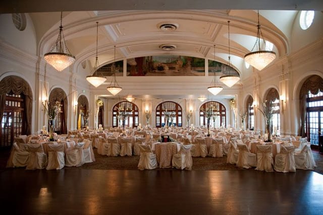 Elegant Crystal Ballroom banquet hall with round tables, ideal for weddings and corporate events.