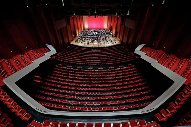 Jones Hall auditorium with tiered red seating, ideal for orchestral performances and events.