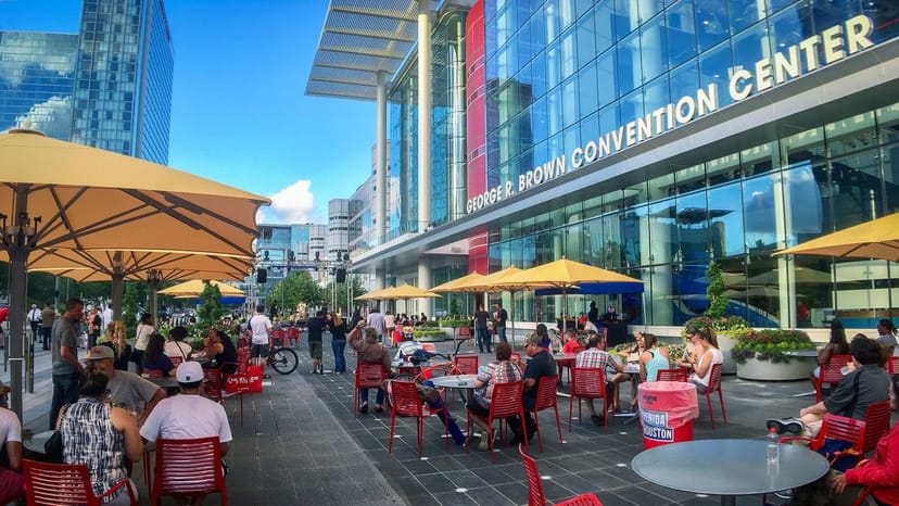 Vibrant outdoor conference space at 1000 Main with colorful umbrellas for networking events.