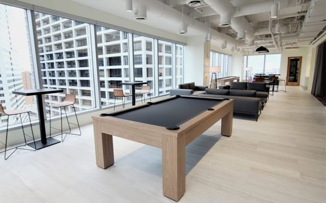 Modern conference lounge with pool table, perfect for networking and casual meetings.