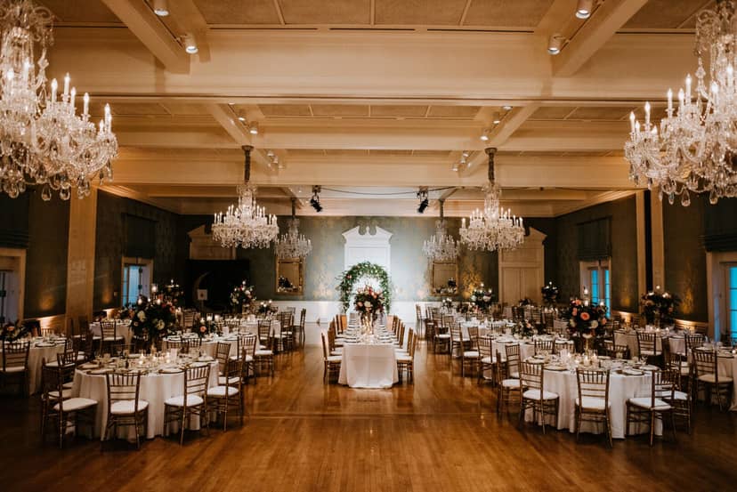 Elegant ballroom with floral centerpieces for weddings and upscale events.