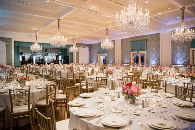 Elegant banquet hall with floral centerpieces, ideal for weddings and corporate galas.
