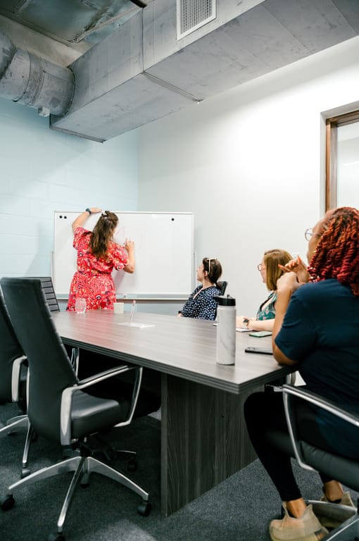 Houston women's center conference room with whiteboard for interactive workshops.