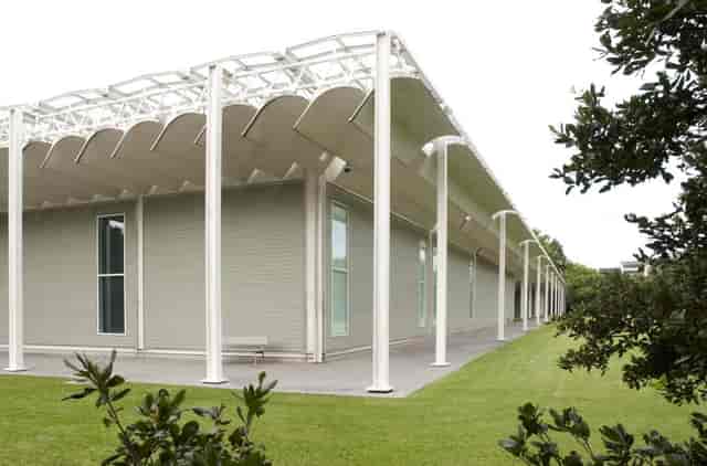 Modern event space at The Menil Collection with natural light and greenery.