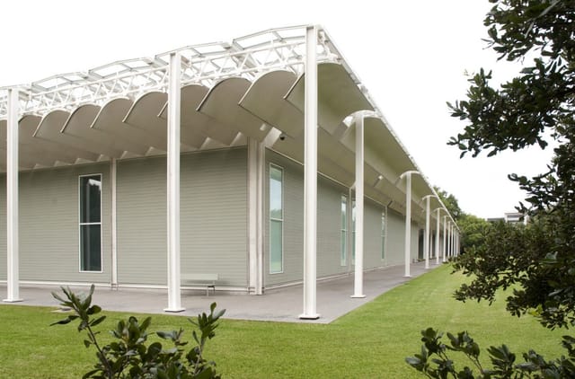 Modern event space at The Menil Collection with natural light and greenery.