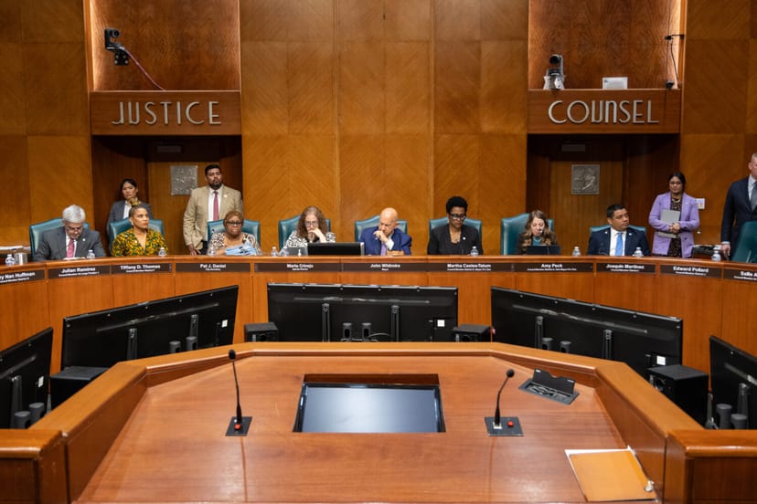 Corporate office meeting room in Houston with labeled seating for governance discussions.