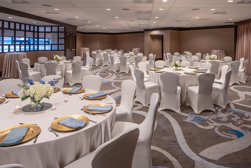 Elegant meeting room at Sheraton Houston with white linens for corporate events.