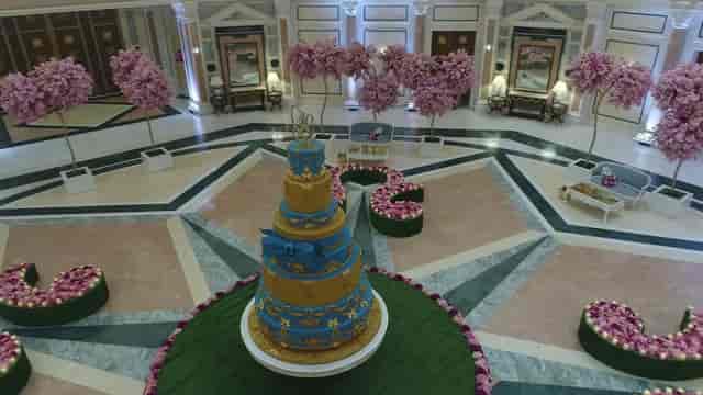 Wedding venue at The Ritz-Carlton Riyadh with elegant floral decor and tiered cake.