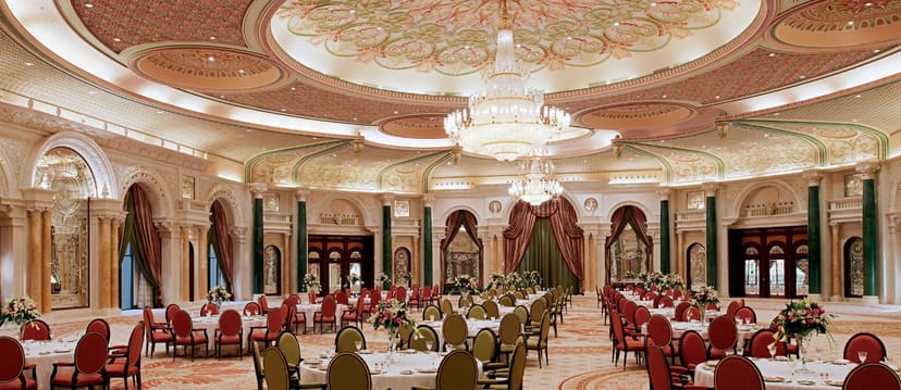 Elegant wedding venue at The Ritz-Carlton, Riyadh with floral centerpieces and chandelier.