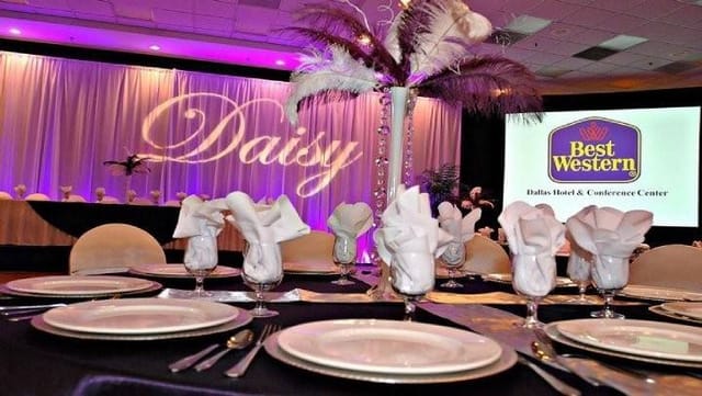 Elegant dining table with feather centerpiece at Best Western Dallas event venue.