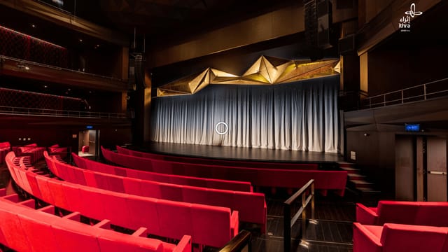 Modern Ithra cinema auditorium with vibrant red seating, perfect for events and performances.