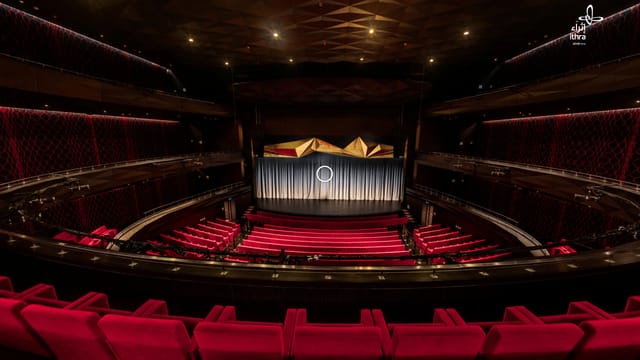 Elegant theater in Ithra with red upholstery, ideal for corporate events and performances.