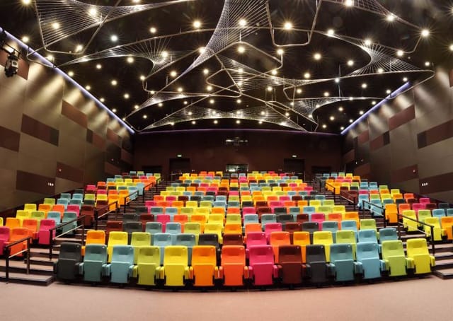 Modern theater auditorium in Ithra with colorful seating for events and presentations.