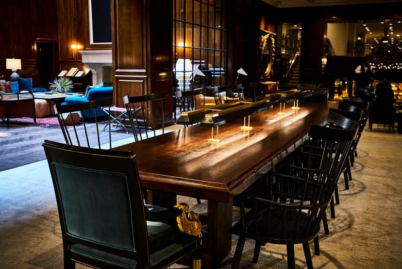 Elegant meeting room in The Adolphus Hotel with wooden table, ideal for presentations.